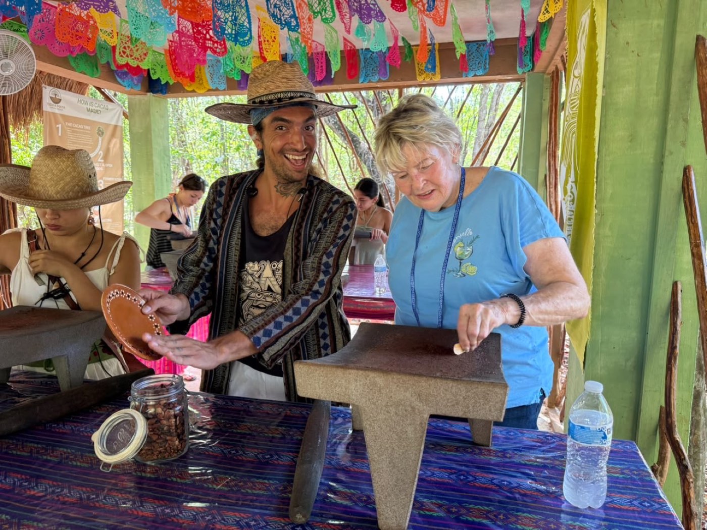 A guest grinding at the metate